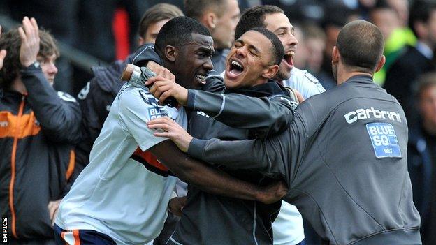 Luton players celebrate at the Racecourse Ground