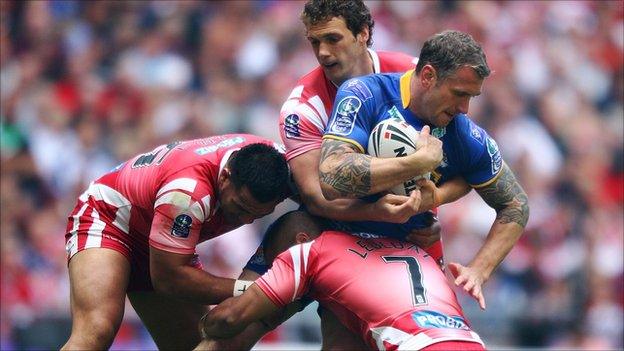 Jamie Peacock for Leeds battles with the Wigan pack