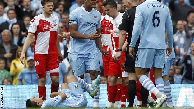 QPR captain Joey Barton kicks out at Manchester City striker Sergio Aguero