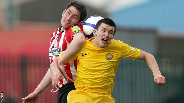 Derry's Ruaidhri Higgins tussles for the ball with Jason Marks