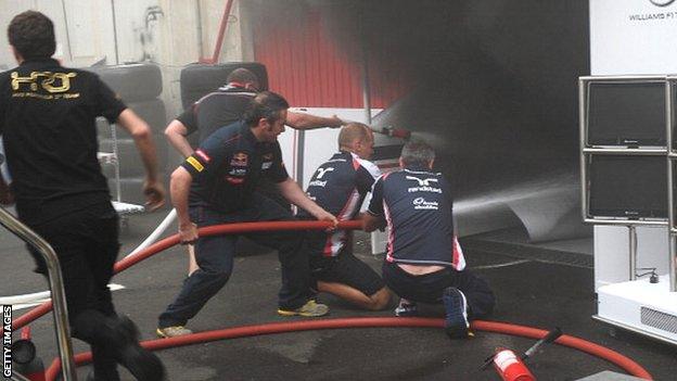 F1 crews fight the fire in the Williams garage