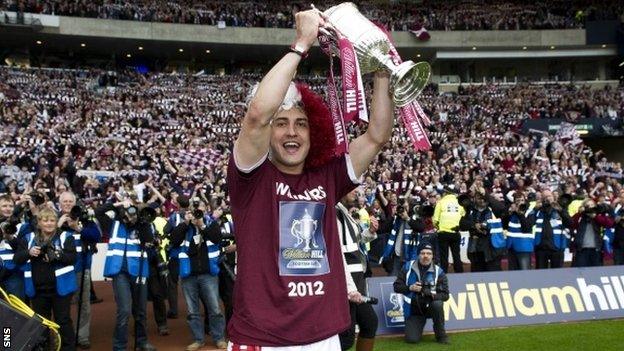 Skacel celebrates by lifting the Scottish Cup in front of the Hearts fans