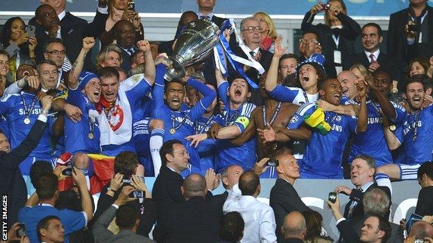 Chelsea players celebrate with the Champions League trophy