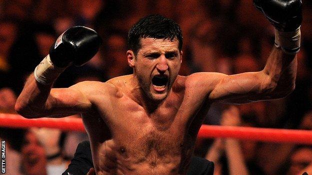 Carl Froch celebrates beating Lucian Bute