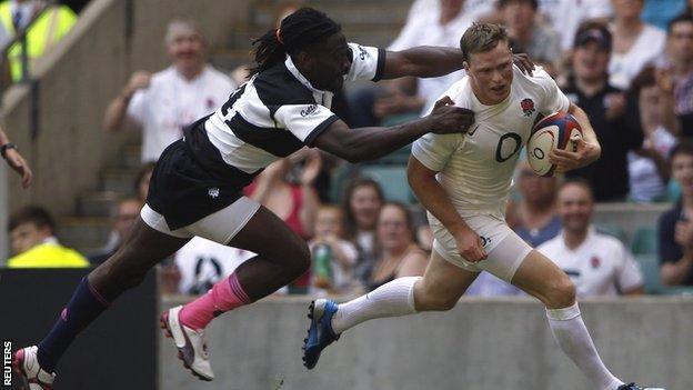 England wing Chris Ashton holds off the tackle of Paul Sackey to score his second try