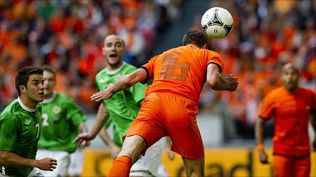 Robin van Persie heads in the first of the six goals scored by the Netherlands aganst Northern Ireland