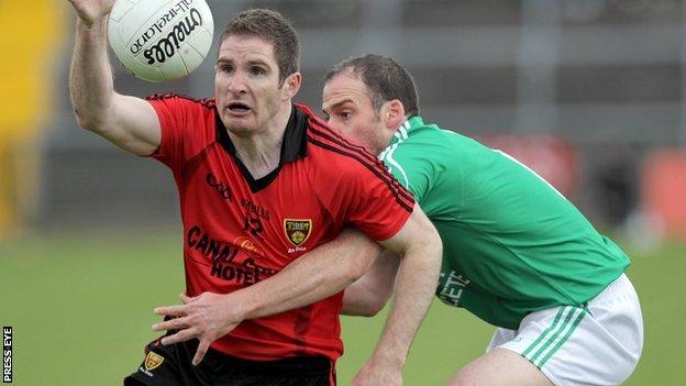 Down's Aidan Carr in possession against Brian Og Maguire of Fermanagh