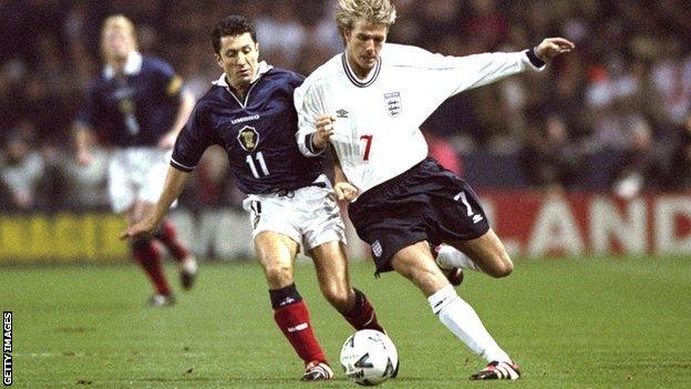 John Collins and David Beckham battle for the ball in 1999