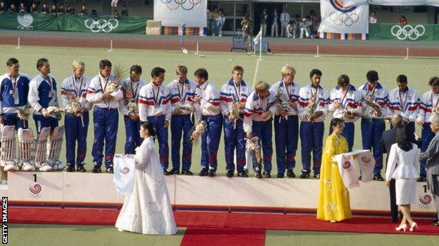 GB men's field hockey team on the podium in Seoul. Veryan Pappin is second left.