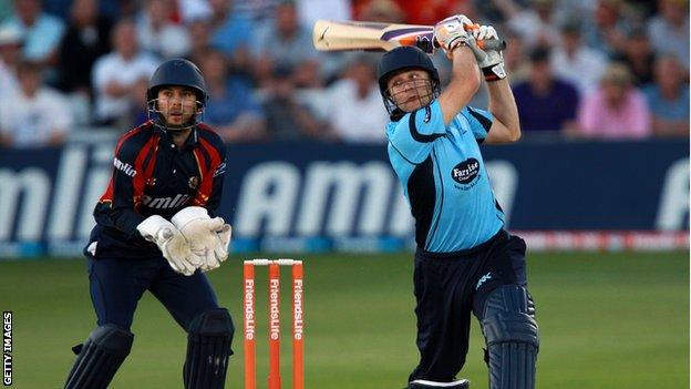 Luke Wright of Sussex hits out with James Foster of Essex looking on during the Friends Life T20 match between Essex and Sussex