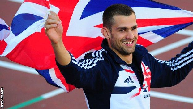 Robbie Grabarz holds the British flag aloft after winning high jump gold