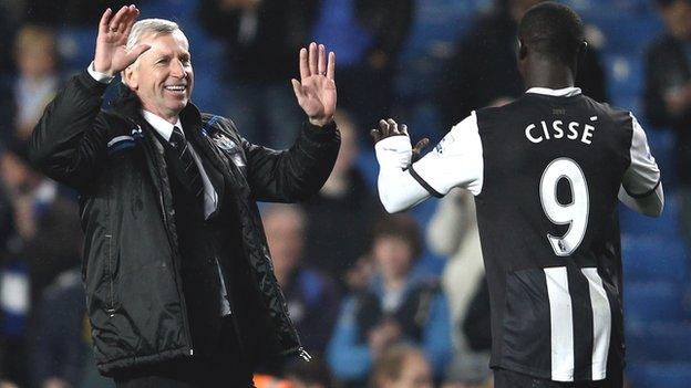 Newcastle manager Alan Pardew (left) celebrates with Senegal's Papiss Demba Cisse