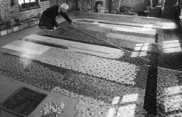 Artist John Piper at work on mosaic mural