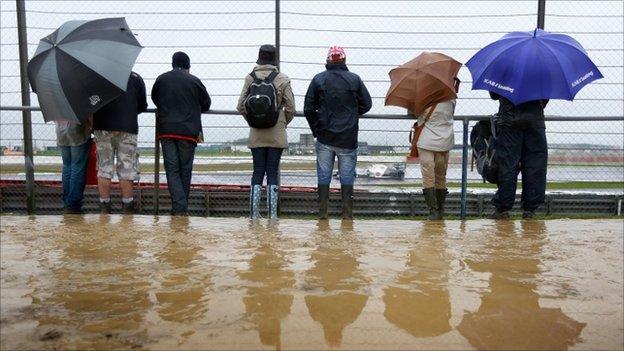 Fans watch in wet and muddy conditions during practice for the British Grand Prix at Silverstone