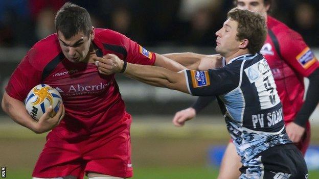 Edinburgh's Stuart McInally is tackled by Chris Cusiter