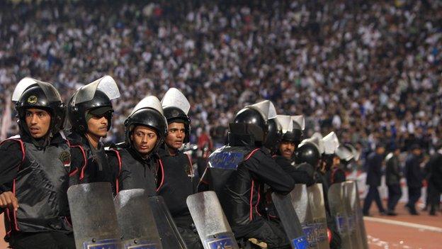 Riot police monitor an Egyptian football match