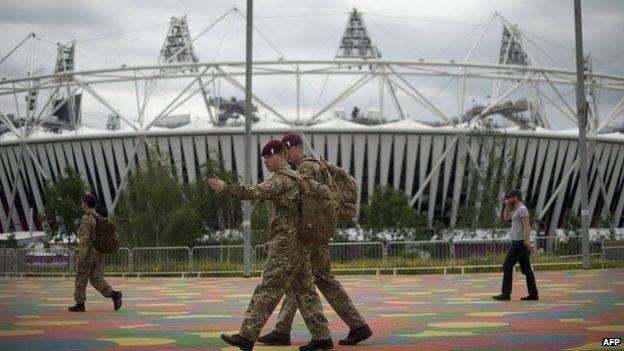 British military personnel walk past the Olympic Stadium ahead of the London 2012 Olympic Games