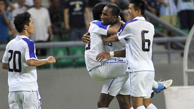 Didier Drogba is congratulated after setting up a goal on his Chinese League debut