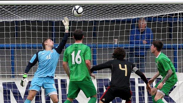 NI keeper Gareth Deane tips Antoni Briseno's header over the bar