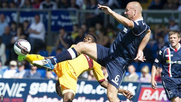 Motherwell's Omar Daley is challenged by Ross Tokely at Victoria Park