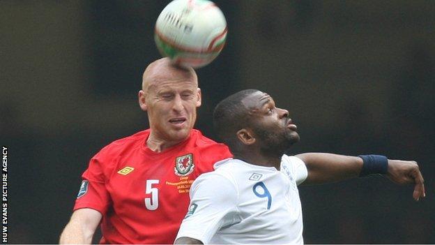 James Collins challenges England's Darren Bent in his last game for Wales in March 2011