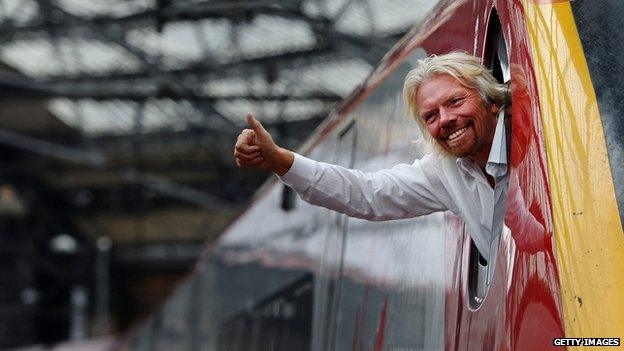 Richard Branson leaning out of the window of a Virgin Pendolino train