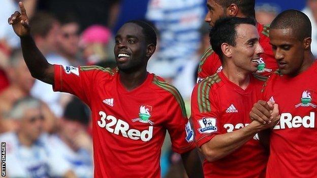 Nathan Dyer (left) celebrates Swansea's third goal with Leon Britton and Wayne Routledge