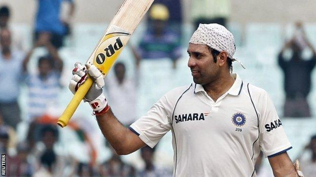 India's VVS Laxman raises his bat to celebrate his century on the second day of their second test cricket match against West Indies in Kolkata in this November 15, 2011