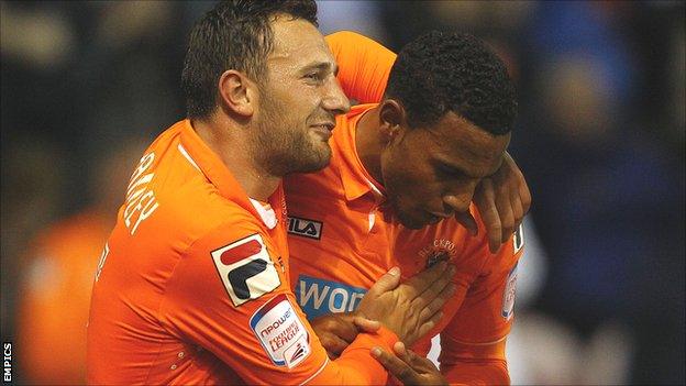 Blackpool's Neal Eardley (l) celebrates with Matt Phillips after the winger's winning goal against Leeds on Tuesday