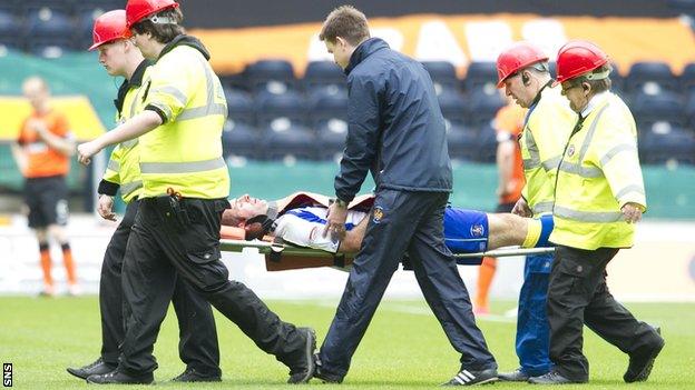 Gary Harkins is taken off on a stretcher