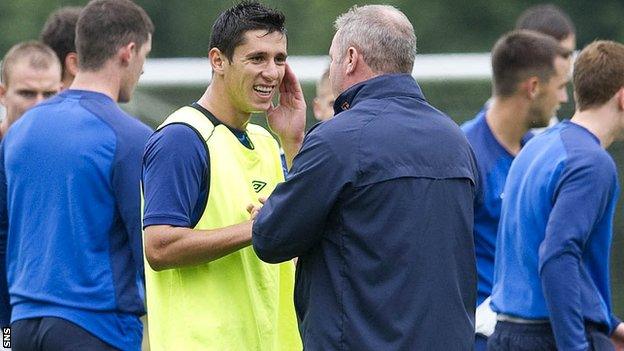 Anestis Argyriou chats with manager Ally McCoist during training