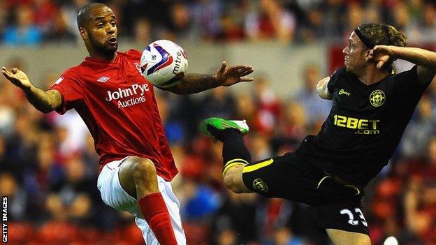 David McGoldrick [l] battles with Wigan's Ronnie Stam