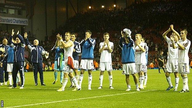 Hearts players applaud their supporters at Anfield