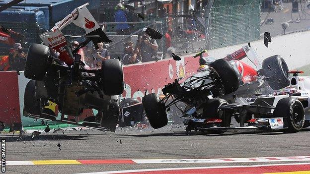 Fernando Alonso (left) and Lewis Hamilton (right) collide and crash out at the first corner at the start of the Belgian Grand Prix