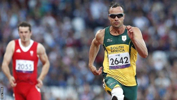 South Africa's Oscar Pistorius (right) wins his men's T44 100m heat