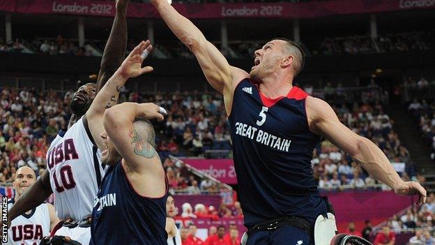 GB's Dan Hitchcock and Abdi Jama of USA reach for the ball during their bronze medal match