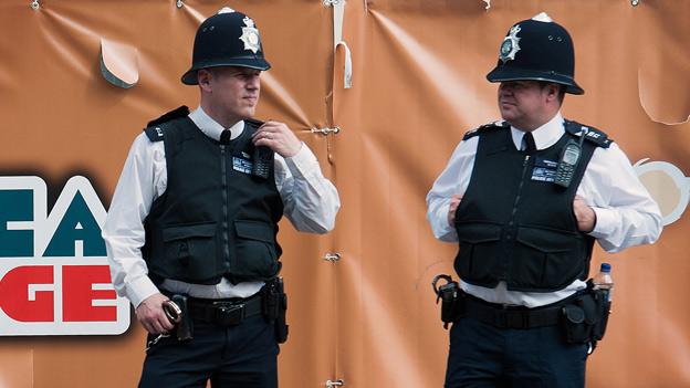 Two police officers - one has a bottle of water in his utility belt