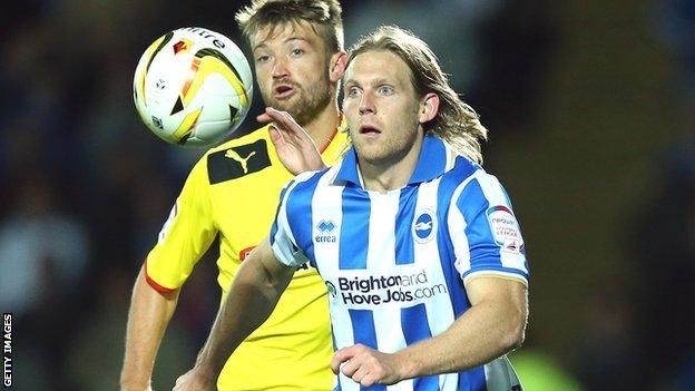 Craig Mackail-Smith of Brighton (right) holds off Neuton of Watford