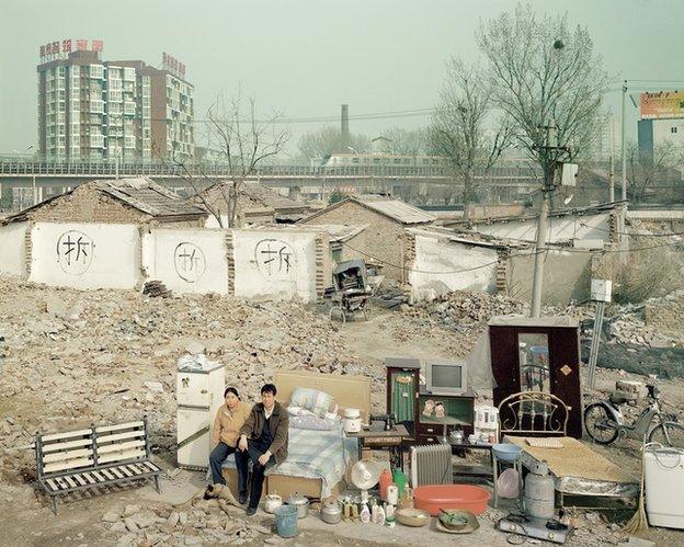 Chinese couple by demolition site