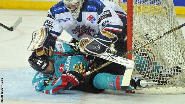 Dundee netminder Nic Riopel tangles with Belfast's Greg Stewart