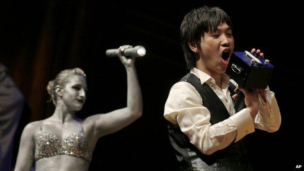 Koji Tsukada yells into his invention the "SpeechJammer" during a performance at the Ig Nobel Prize ceremony