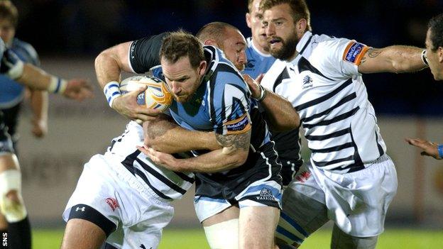 Morrison is held up as he races for the Zebre line at Scotstoun