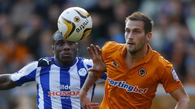 Roger Johnson of Wolves (R) battles for the ball with Michail Antonio of Sheffield Wednesday