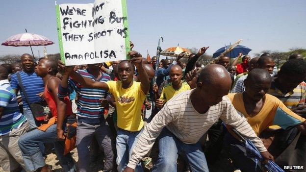 Striking platinum miners march near the Anglo-American Platinum mine near Rustenburg, South Africa, 5 October 2012