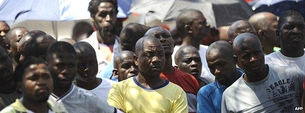 Striking mine workers gather outside the Anglo American mine on 5 October 2012 in Rustenburg. South Africa