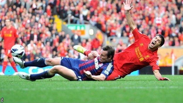 Luis Suarez is challenged by Stoke's Dean Whitehead