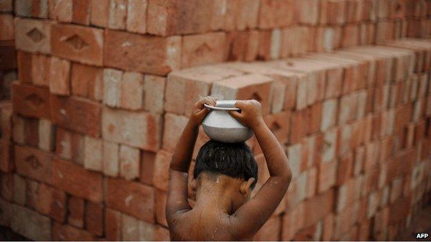 Boy carrying water in quarry