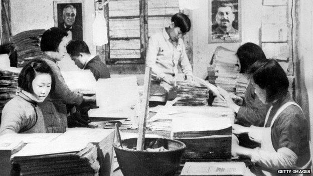 A section of the printing plant run by the communists in Northern China. Photographs of Stalin and President Franklin Delano Roosevelt are seen on the walls. Mao Tse Tung rules the area with an iron fist and as a consequence the area is in fact a state within a state.