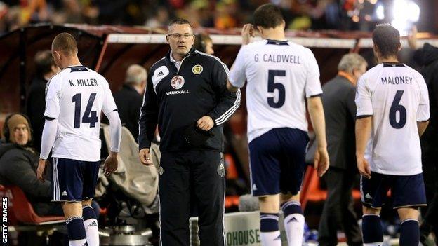 Craig Levein and his players troop off after the defeat in Brussels