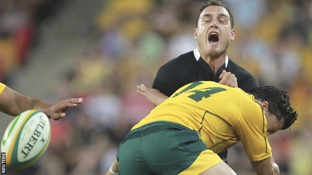 All Blacks full-back Israel Dagg loses the ball as he is tackled by Australia's Adam Ashley-Cooper